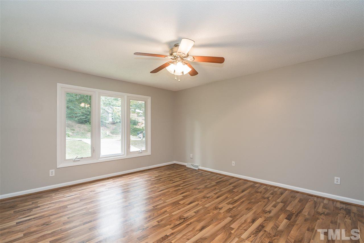 6704 Winding Trail Raleigh, NC 27612 - Photo 5 of 30 a view of empty room with wooden floor and fan