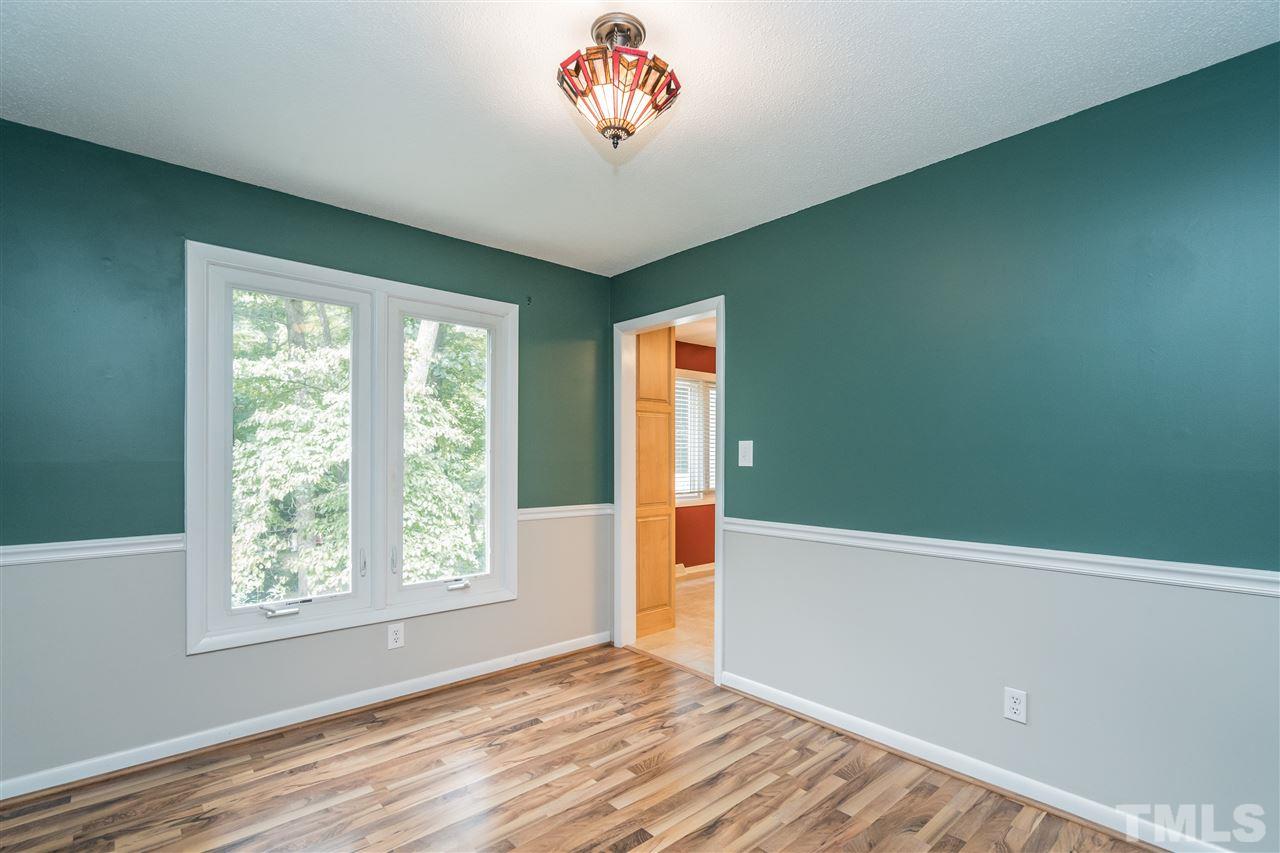 6704 Winding Trail Raleigh, NC 27612 - Photo 7 of 30 a view of a livingroom with wooden floor and a window