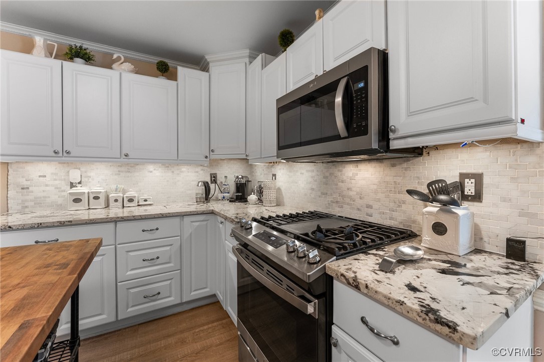200 St Georges Boulevard Williamsburg, VA 23185 - Photo 14 of 49 Kitchen with backsplash, crown molding, white cabi