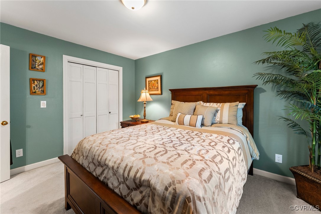 200 St Georges Boulevard Williamsburg, VA 23185 - Photo 27 of 49 Bedroom with light carpet, baseboards, and a close