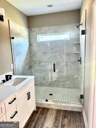 a bathroom with a sink a mirror and shower