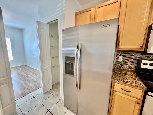 15609 Stable Run Drive Spring Hill, FL 34610 - Photo 11 of 37 a kitchen with stainless steel appliances granite countertop a refrigerator and a stove