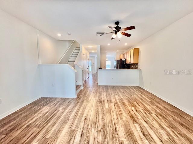15609 Stable Run Drive Spring Hill, FL 34610 - Photo 13 of 37 a view of a room with wooden floor and a ceiling fan