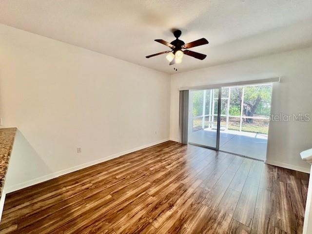 15609 Stable Run Drive Spring Hill, FL 34610 - Photo 14 of 37 a view of an empty room with wooden floor and a window