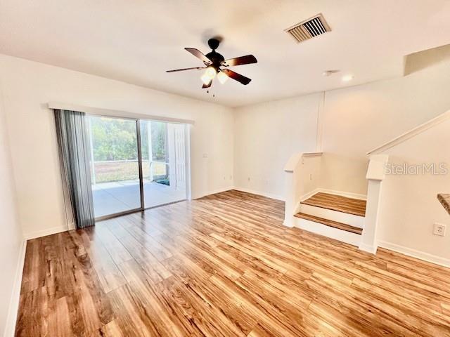 15609 Stable Run Drive Spring Hill, FL 34610 - Photo 15 of 37 a view of empty room with wooden floor and fan