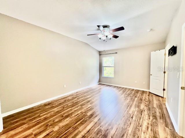 15609 Stable Run Drive Spring Hill, FL 34610 - Photo 18 of 37 a view of an empty room with wooden floor and a window
