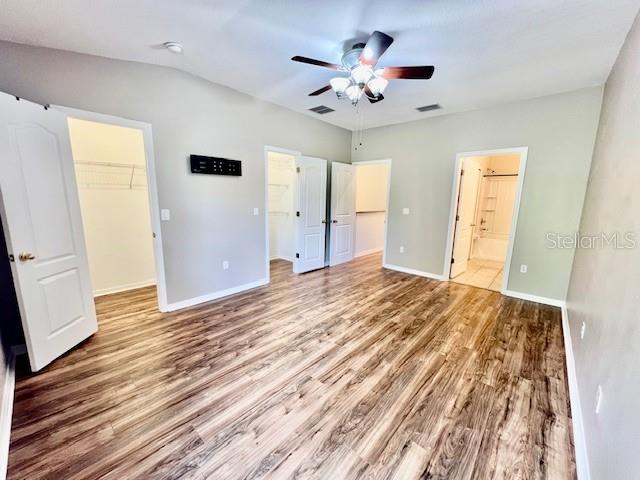 15609 Stable Run Drive Spring Hill, FL 34610 - Photo 20 of 37 a view of a livingroom with wooden floor and a ceiling fan