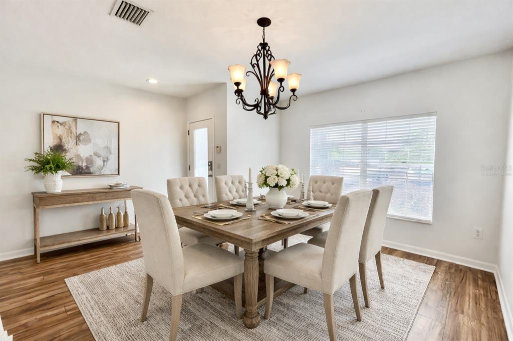 15609 Stable Run Drive Spring Hill, FL 34610 - Photo 2 of 37 a view of a dining room with furniture window and wooden floor