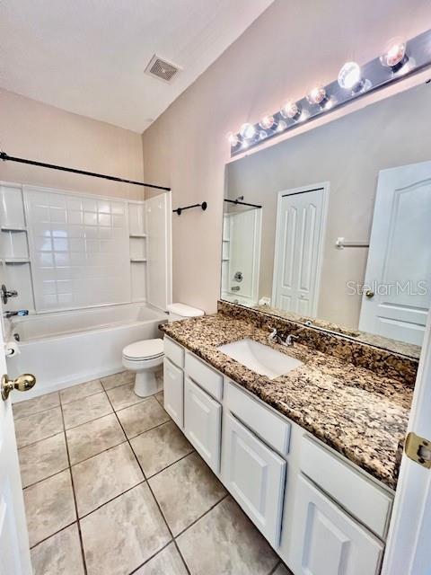15609 Stable Run Drive Spring Hill, FL 34610 - Photo 23 of 37 a bathroom with a granite countertop sink a toilet and shower