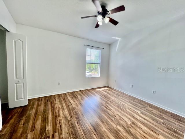 15609 Stable Run Drive Spring Hill, FL 34610 - Photo 25 of 37 a view of empty room with wooden floor and fan