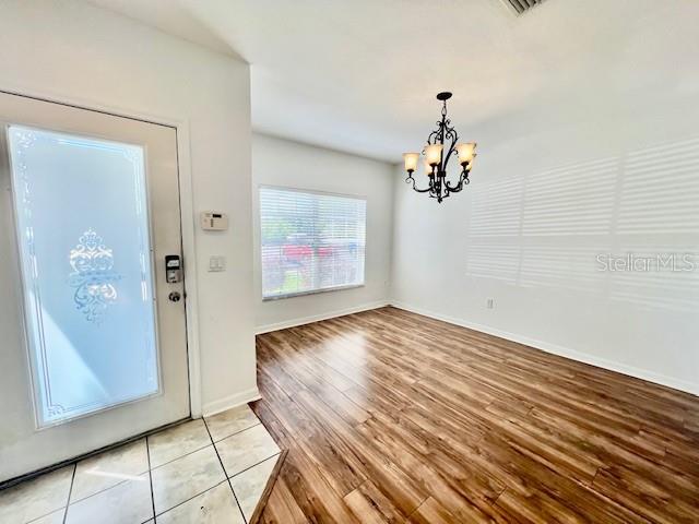 15609 Stable Run Drive Spring Hill, FL 34610 - Photo 3 of 37 wooden floor in an empty room with a window