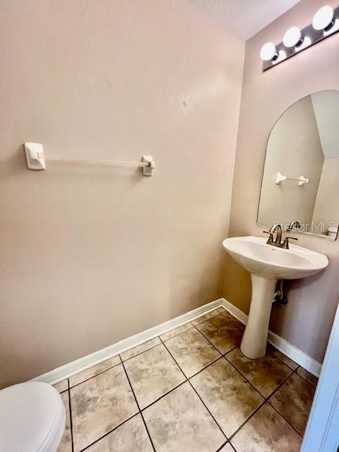 15609 Stable Run Drive Spring Hill, FL 34610 - Photo 31 of 37 a bathroom with a sink a toilet and mirror