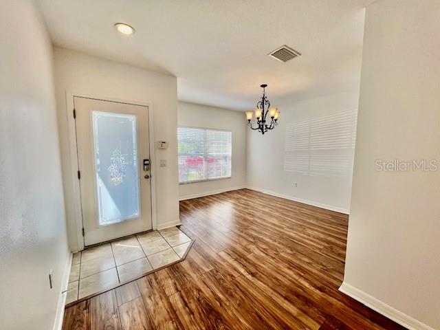 15609 Stable Run Drive Spring Hill, FL 34610 - Photo 4 of 37 an empty room with wooden floor and cabinet