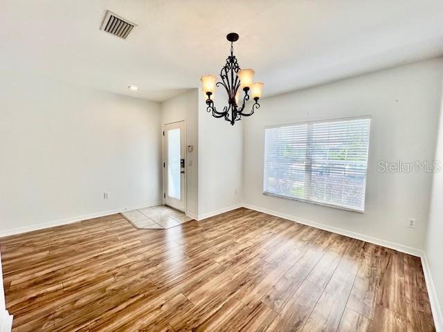 15609 Stable Run Drive Spring Hill, FL 34610 - Photo 5 of 37 a view of an empty room with wooden floor and a window