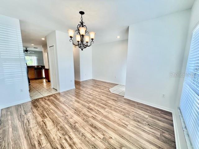 15609 Stable Run Drive Spring Hill, FL 34610 - Photo 6 of 37 en empty room with wooden floor and ceiling fan