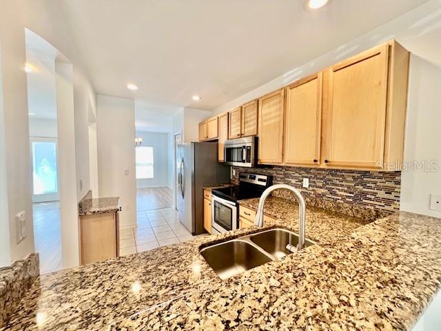 15609 Stable Run Drive Spring Hill, FL 34610 - Photo 8 of 37 a bathroom with a granite countertop sink and a mirror