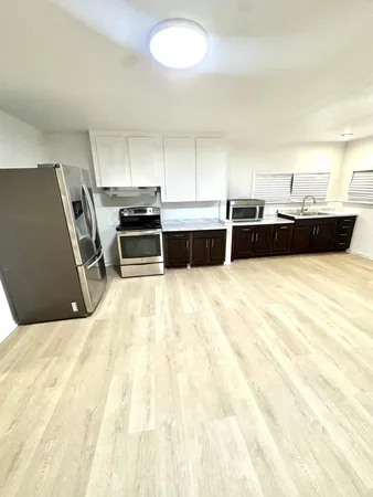 a kitchen with stainless steel appliances a refrigerator and a sink