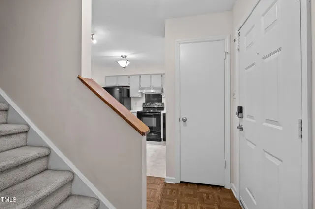 a view of entryway and hall with wooden floor