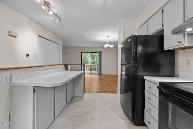 a kitchen with cabinets appliances a sink and a window
