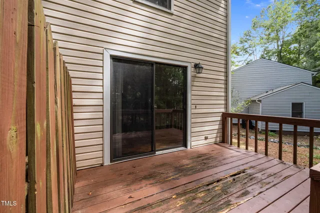 a view of a house with wooden deck