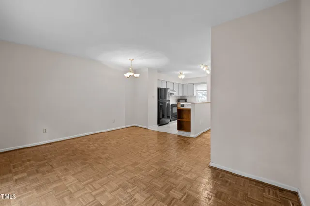 a view of a kitchen with a sink and a chandelier