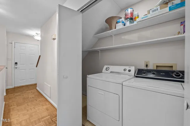 a view of a kitchen with a sink and a refrigerator