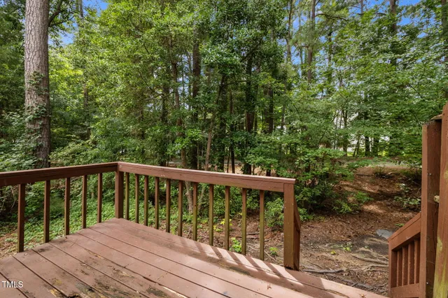 a view of a roof deck with wooden floor and fence