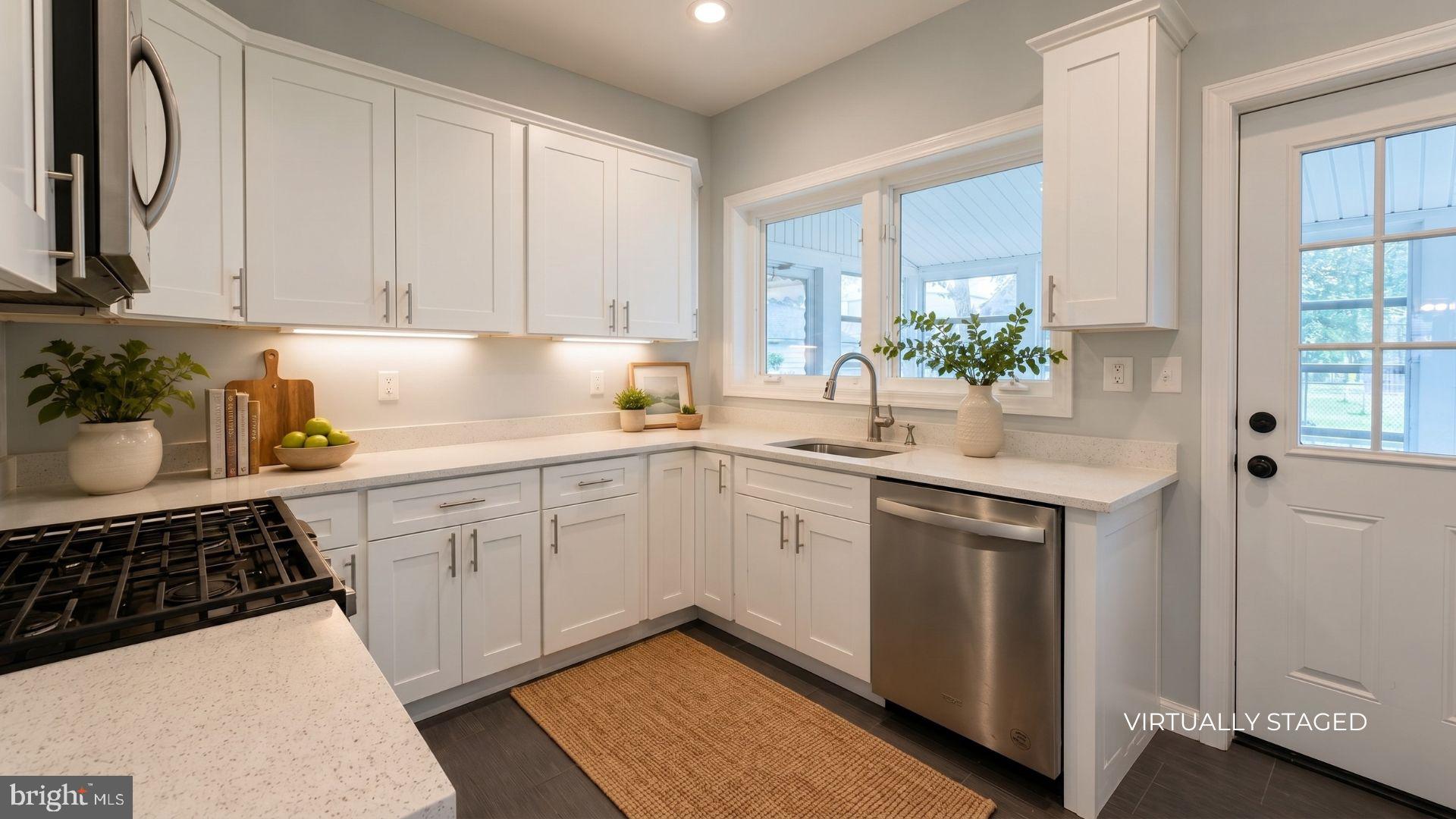 154 Andrew Street Hamilton, NJ 08610 - Photo 8 of 29 a kitchen with a sink a stove cabinets and a window