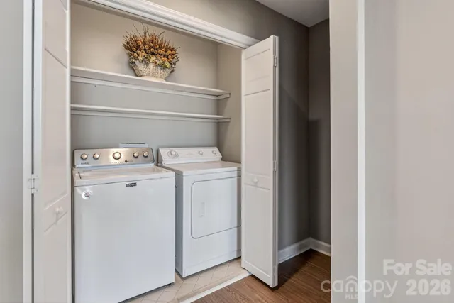 a bedroom with two beds and a chandelier