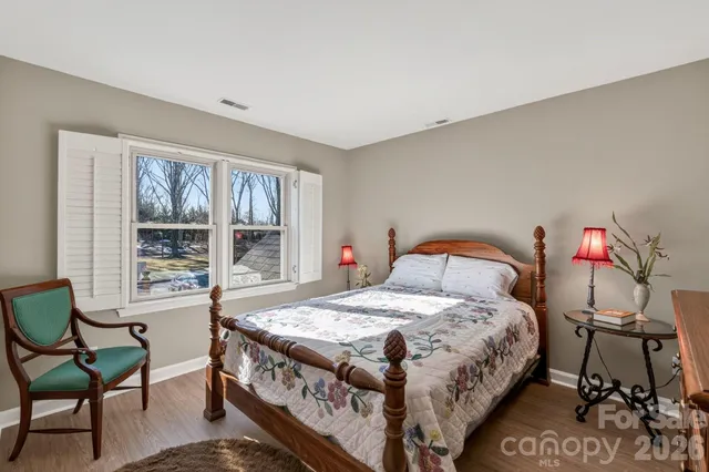 a bathroom with a granite countertop sink a toilet and a mirror