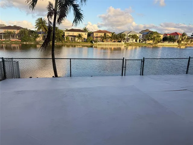 a view of swimming pool with a lawn chairs