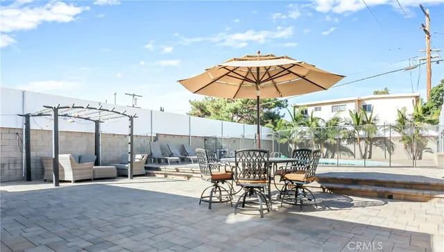 a view of a patio with a table and chairs