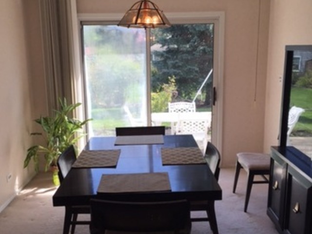 48 Timber Hill Road Buffalo Grove, IL 60089 - Photo 8 of 23 a view of a dining room with furniture window and wooden floor