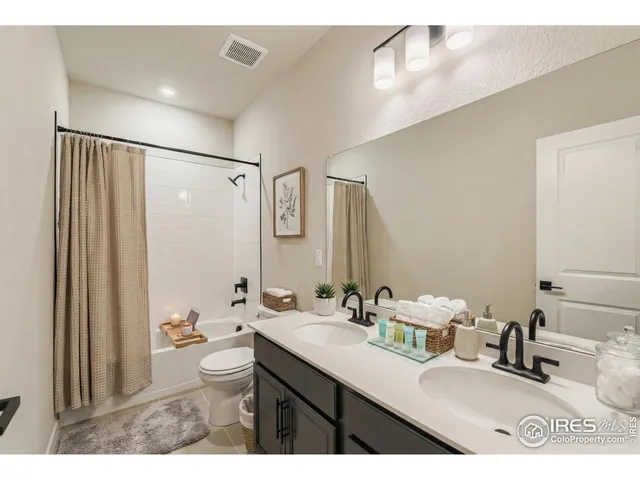 a bathroom with a sink mirror and a toilet