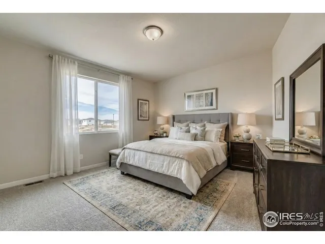 a bedroom with a bed and window