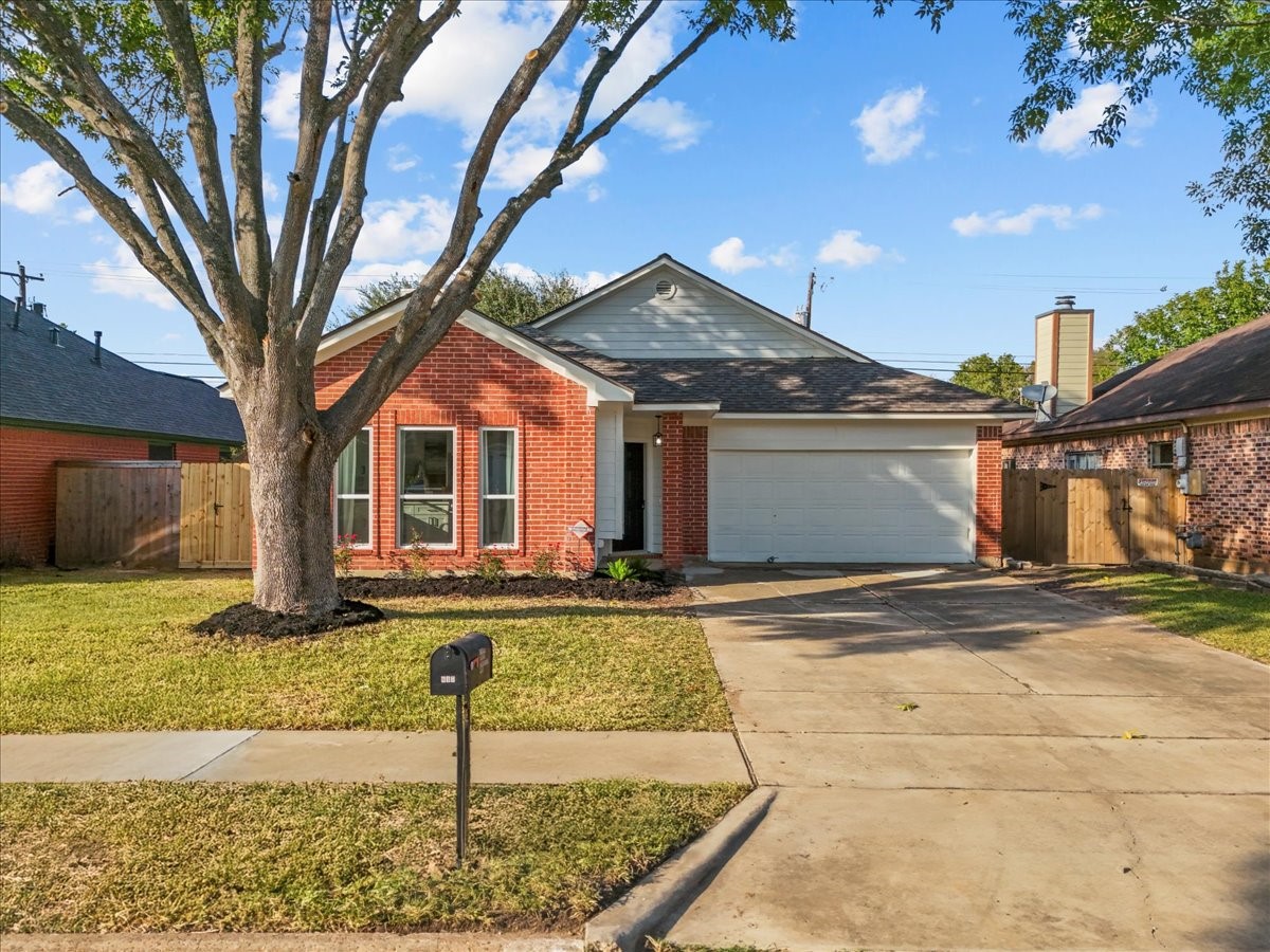 617 Prairie Lane Angleton, TX 77515 - Photo 1 of 14 a front view of a house with garden