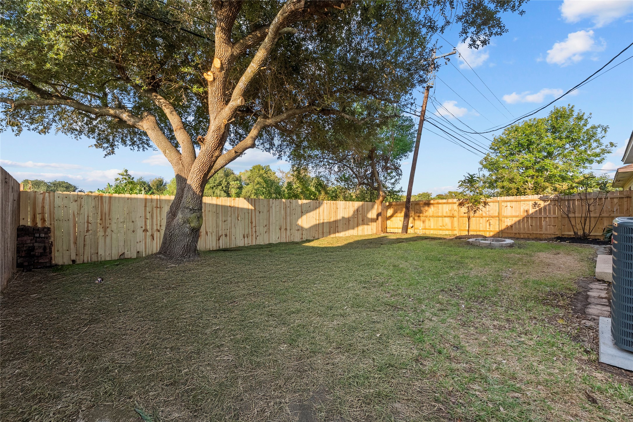 617 Prairie Lane Angleton, TX 77515 - Photo 12 of 14 a view of backyard with tree and wooden fence