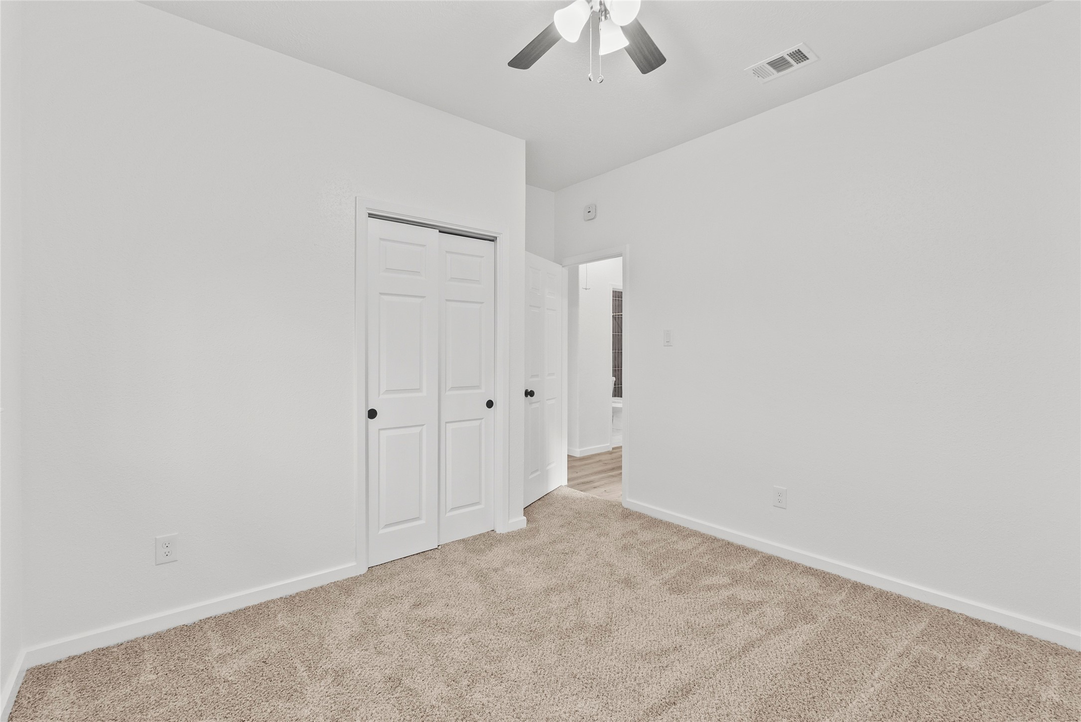 617 Prairie Lane Angleton, TX 77515 - Photo 5 of 14 an empty room with a ceiling fan and a window
