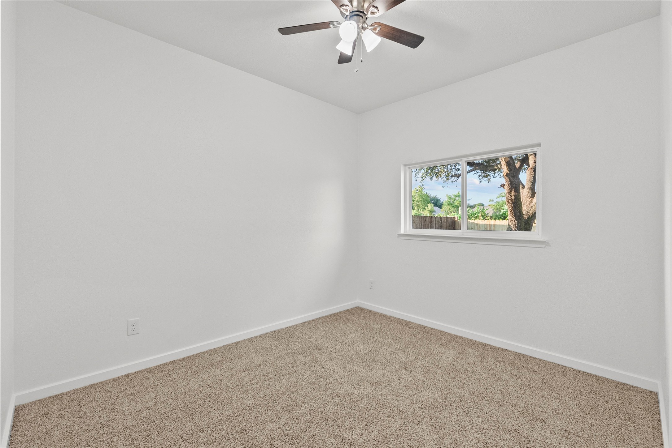 617 Prairie Lane Angleton, TX 77515 - Photo 6 of 14 an empty room with a window and a chandelier fan