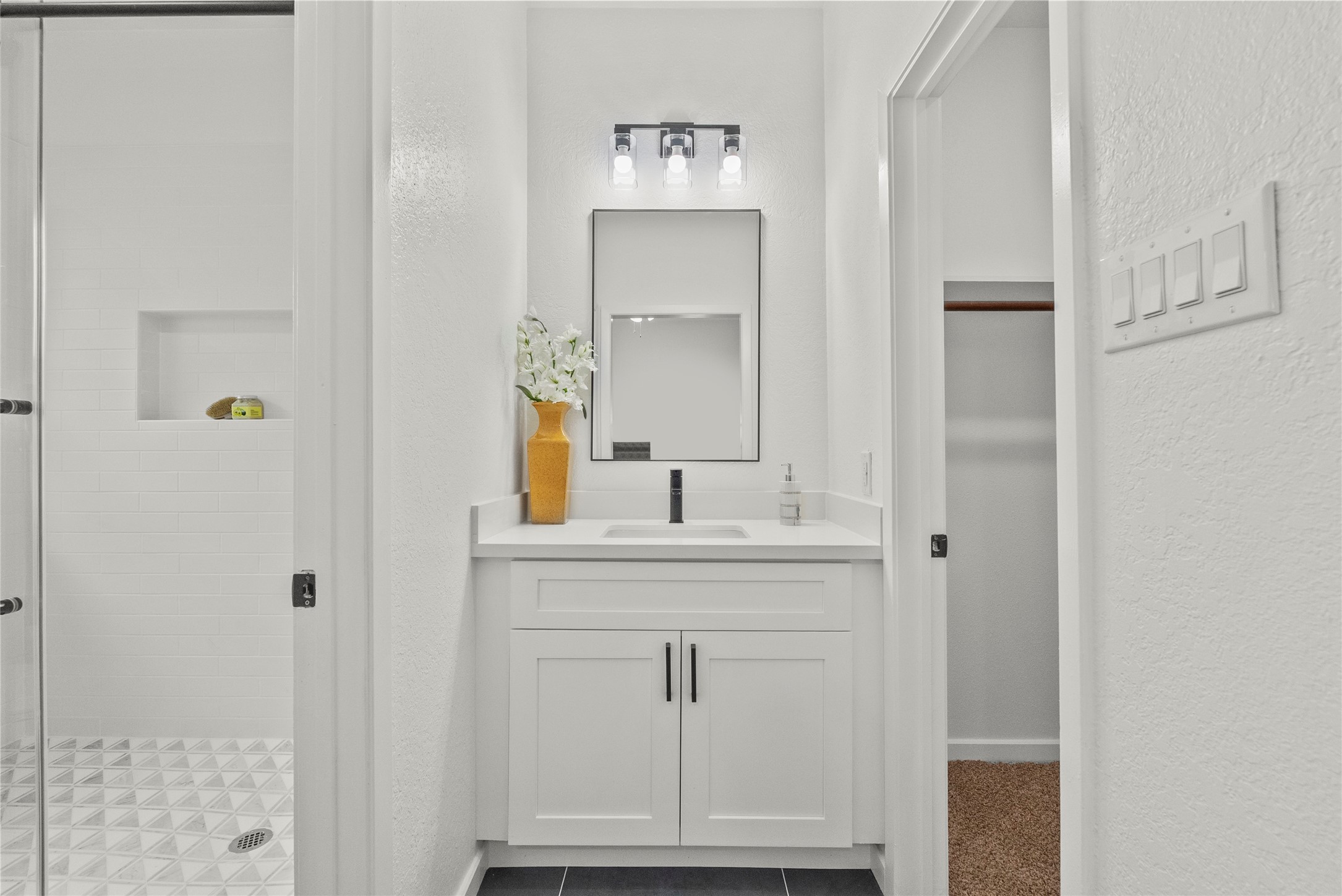 617 Prairie Lane Angleton, TX 77515 - Photo 10 of 14 a bathroom with a shower sink and mirror