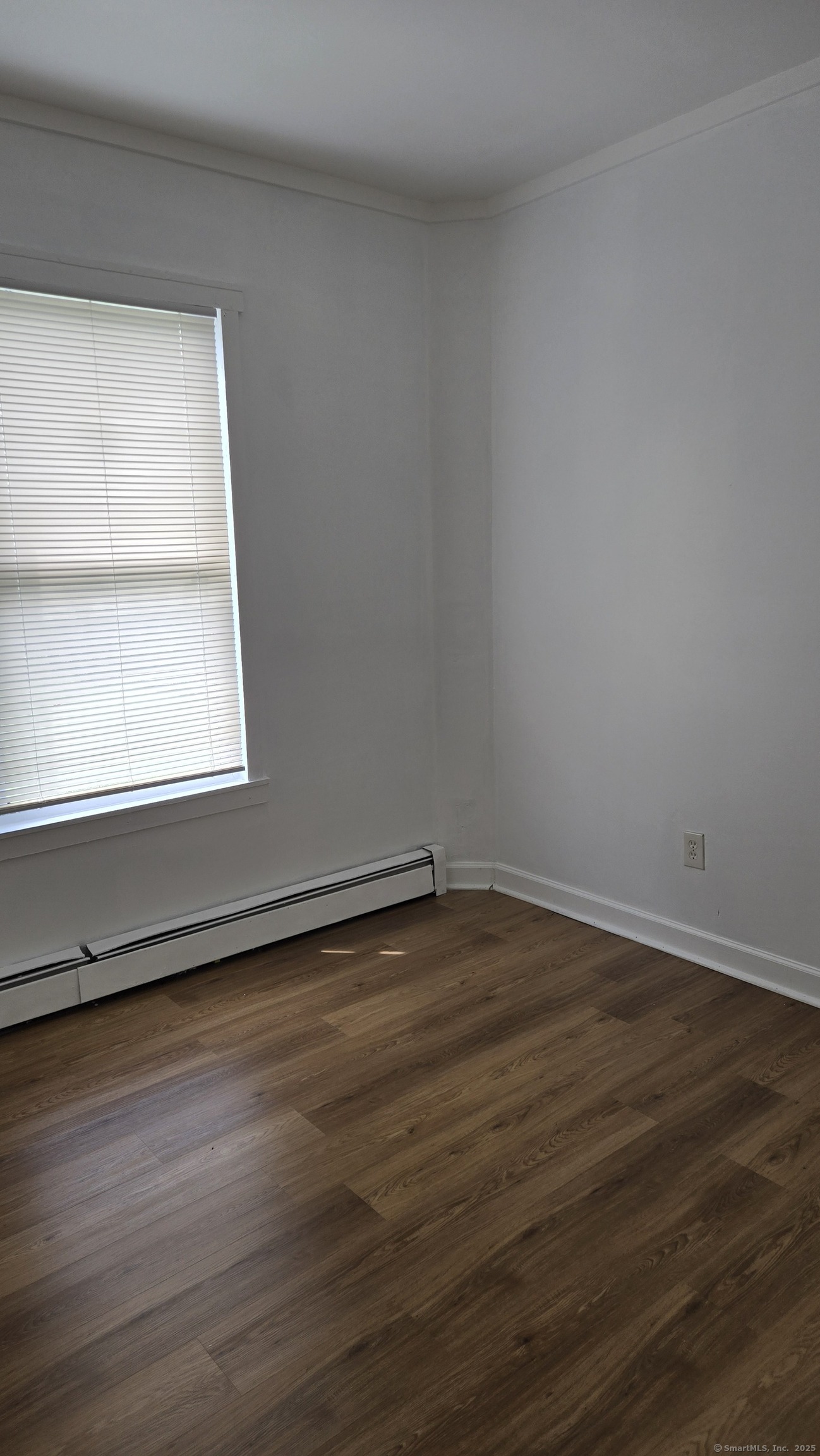 117 Dikeman Street Waterbury, CT 06704 - Photo 11 of 17 a view of a small space with wooden floor and a window