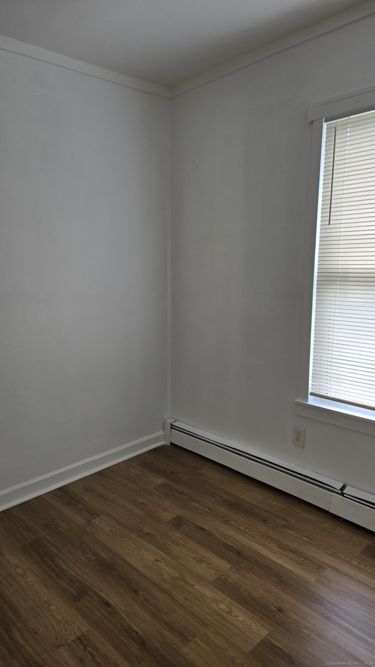 117 Dikeman Street Waterbury, CT 06704 - Photo 12 of 17 a view of a small space with wooden floor and a window