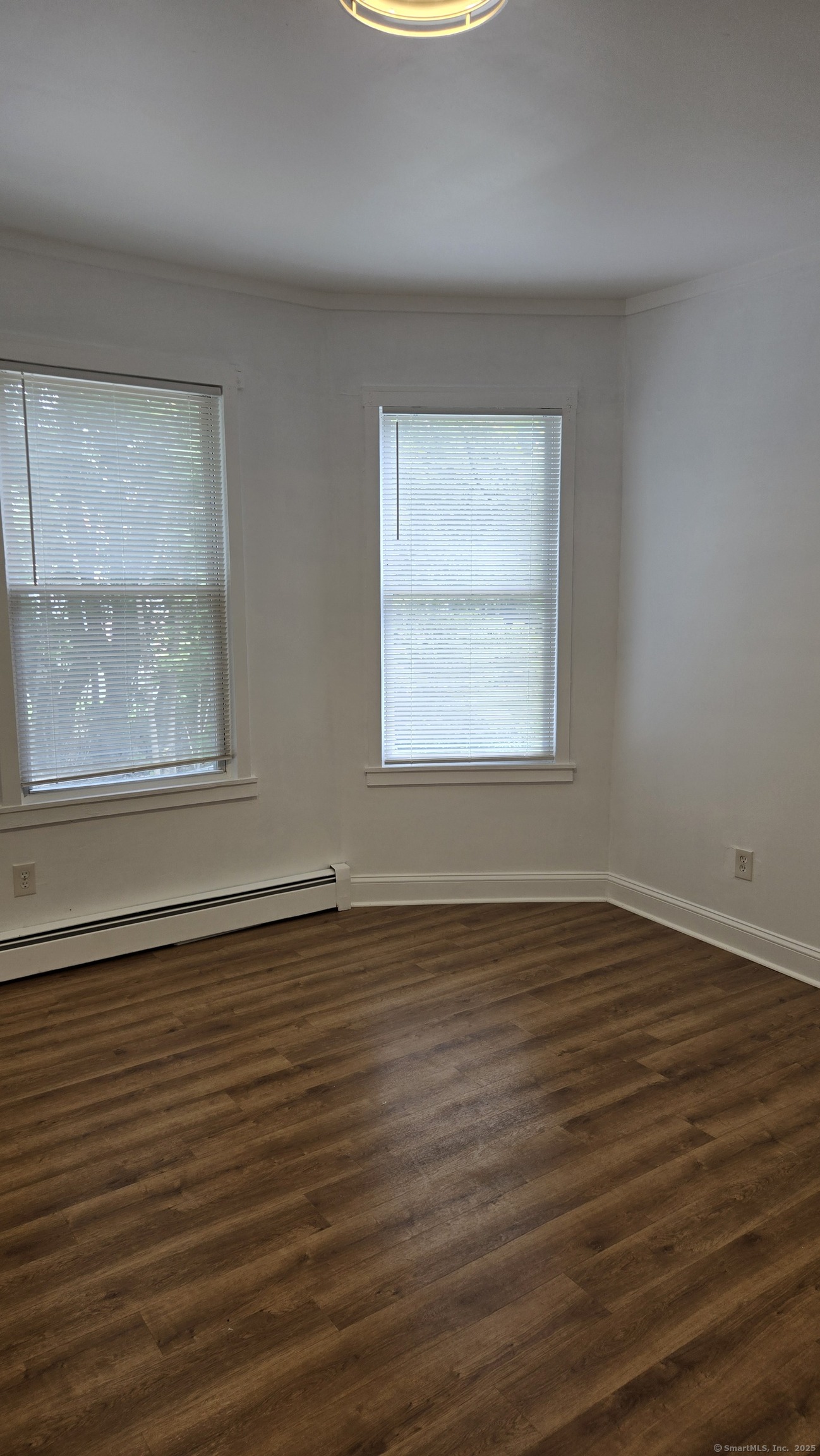 117 Dikeman Street Waterbury, CT 06704 - Photo 7 of 17 a view of an empty room with wooden floor and a window