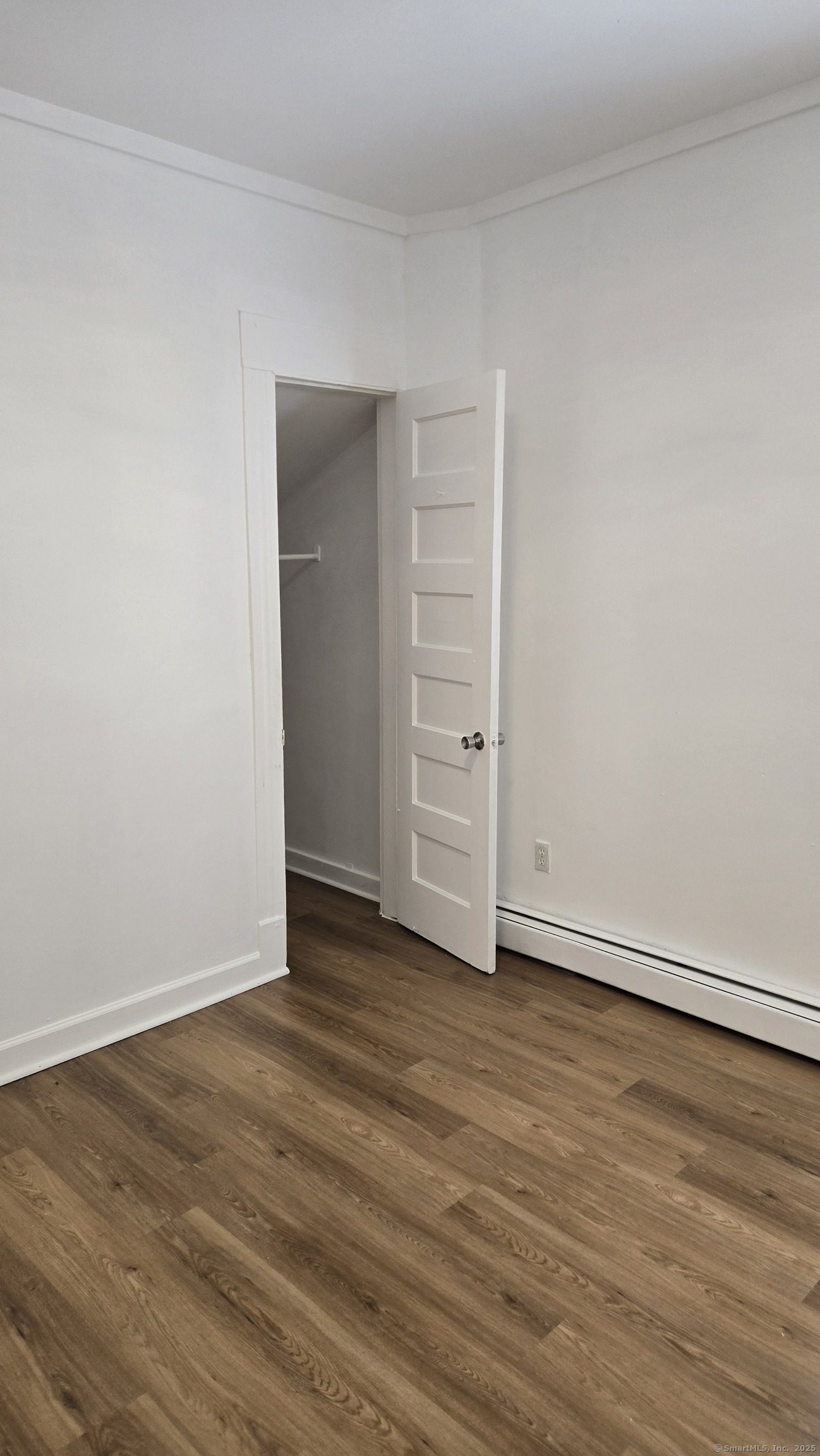 117 Dikeman Street Waterbury, CT 06704 - Photo 9 of 17 a view of an empty room with wooden floor and closet