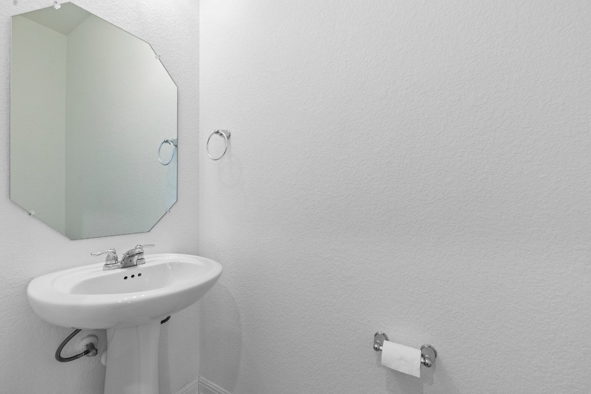 2429 Acoma Lane Leander, TX 78641 - Photo 23 of 39 a bathroom with a sink and mirror