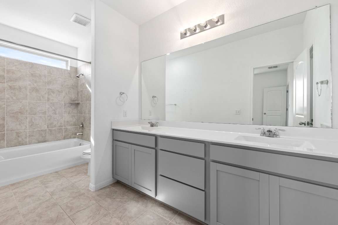 2429 Acoma Lane Leander, TX 78641 - Photo 31 of 39 a bathroom with a double vanity sink mirror double and bathtub