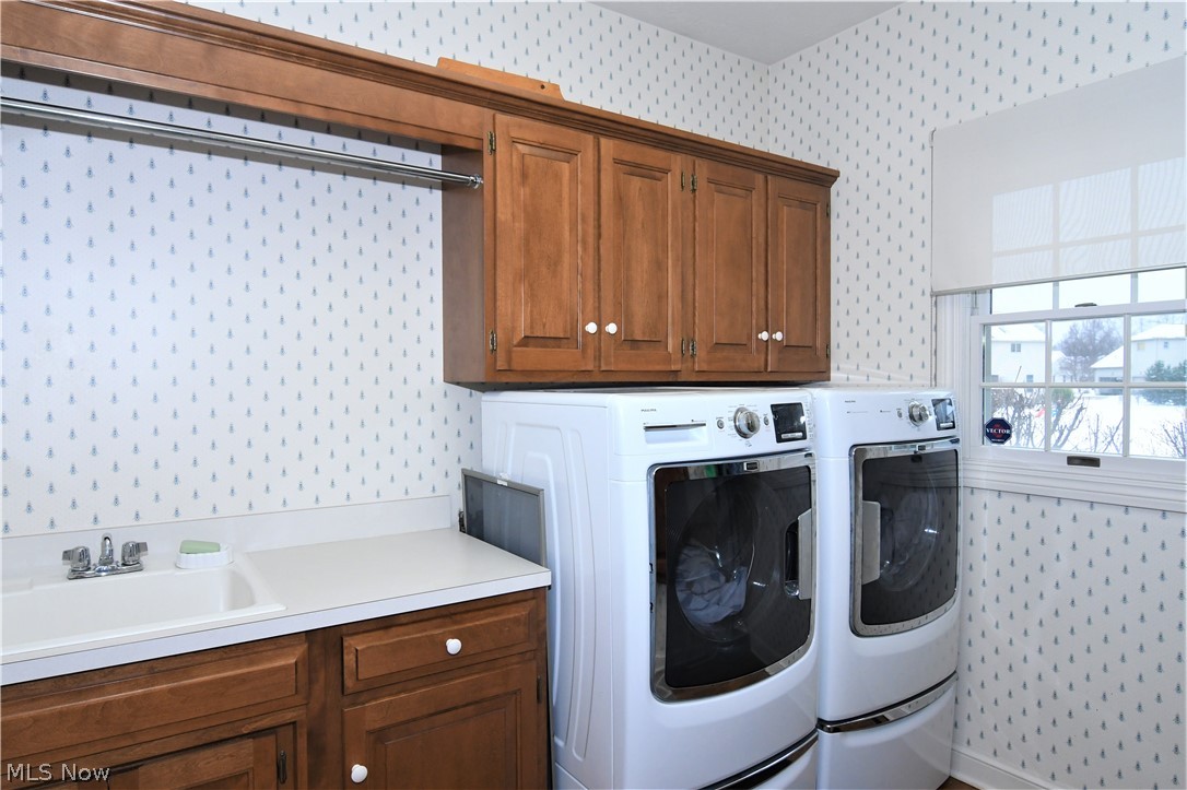 659 Sunridge Road Fairlawn, OH 44333 - Photo 17 of 35 1st floor laundry with washer, dryer, sink, vanity, maple cabinetry and H/W floors