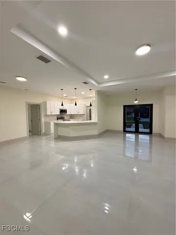 a view of a kitchen with furniture and a refrigerator