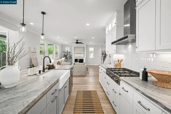 a kitchen with sink stove and cabinets