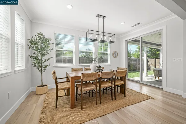 a view of a dining room with furniture window and wooden floor